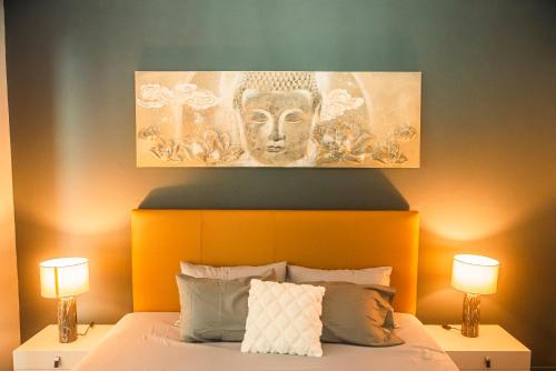 a bed with an orange headboard with a mask above it at Gorgeous KEJ in Pereybere 2 Bed Apartment in Pereybere