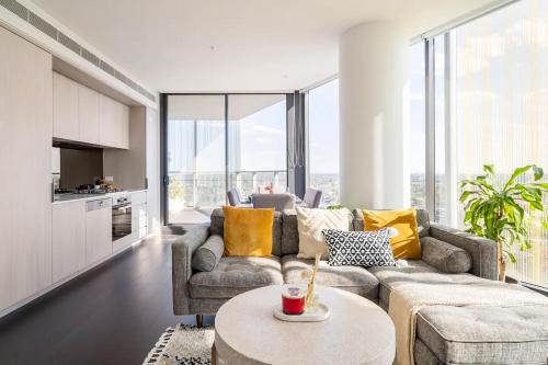 a living room with a couch and a table at The Occidental Pearl in Sydney