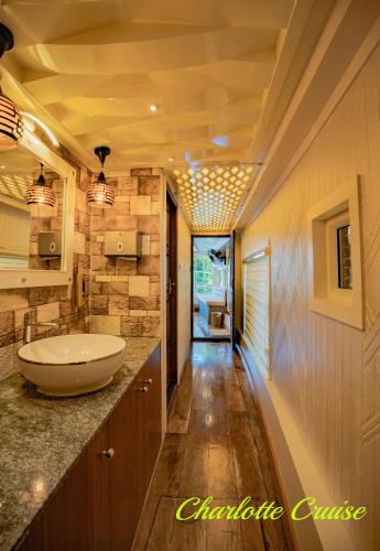 a bathroom with a sink and a toilet in a room at Charlotte Cruise House Boat in Alleppey