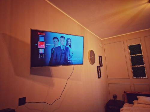 a flat screen tv hanging on a wall at Apartamenty Toskania No.2 in Poznań