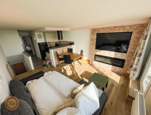 a living room with a couch and a fireplace at Pleskini Apartment in Sankt Englmar