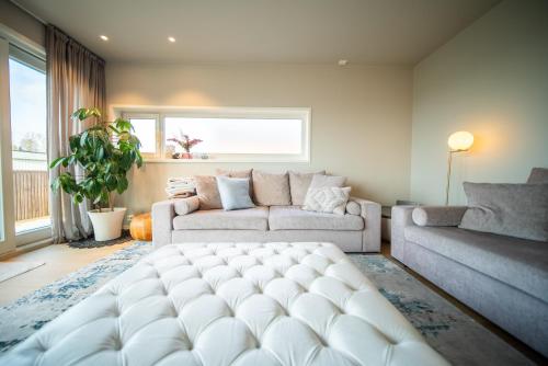 a living room with a large white ottoman at Tromsø Town House in Tromsø