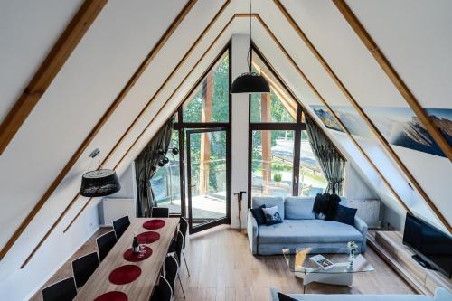 a living room with a blue couch and windows at Harenda Residence in Zakopane