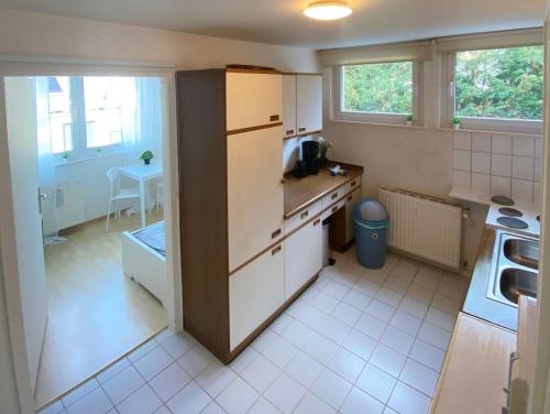 a kitchen with a refrigerator and a table in it at Apartments with Garden in Bad Vilbel