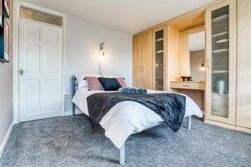 a bedroom with a bed and a closet and a door at Pangbourne House in Higham on the Hill