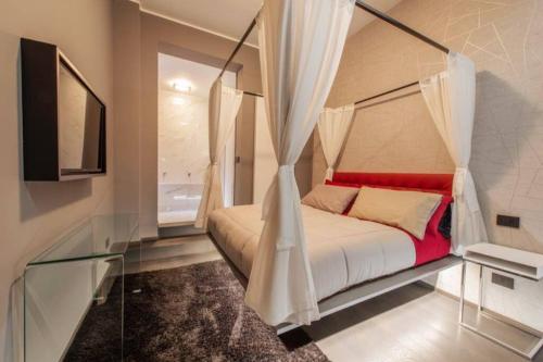 a bedroom with a bed with a canopy at N18 luxury boutique apartment with a private pool & spa in Milan