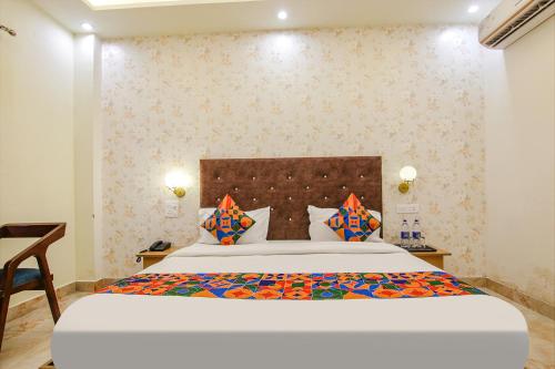 a bedroom with a large bed in a room at FabHotel Crown Star in Dehradun