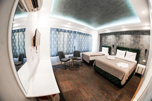 a hotel room with a bed and a mirror at Stay Suite Hotel in Istanbul