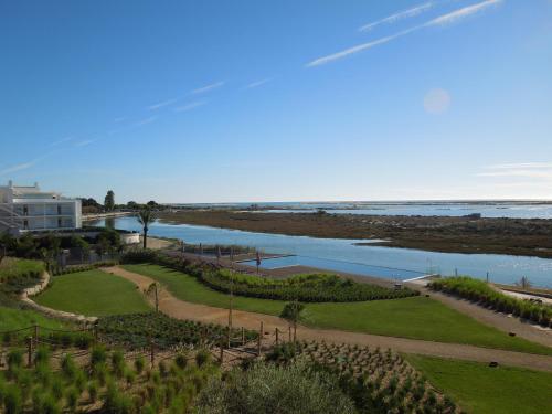 a view of the ocean from the balcony of a resort at Del Mar Village, Apartment T1 , Açor in Fuzeta