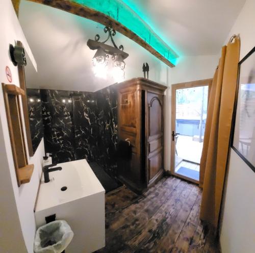 a bathroom with a sink and a mirror at LOVE Room Danslesbois avec spa in Cuges-les-Pins