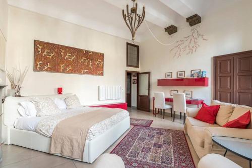 een slaapkamer met een bed, een bank en een tafel bij Piazza Signoria 1, apartment in Florence