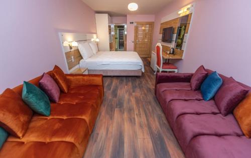 a living room with two couches and a bed at TOK EPİK HOTEL in Bursa