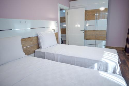 a bedroom with two beds and a mirror at TOK EPİK HOTEL in Bursa