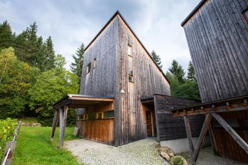 a wooden house with a gambrel roof at Horská chata Harrachov in Harrachov