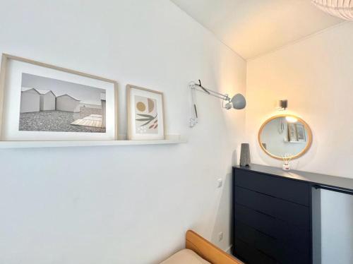 a bedroom with a black dresser and a mirror at Casa Diogo in Faro