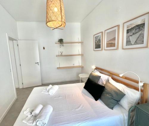 a bedroom with a large bed with towels on it at Casa Diogo in Faro