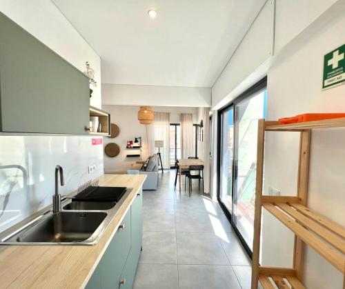 a kitchen with a sink and a counter at Casa Diogo in Faro