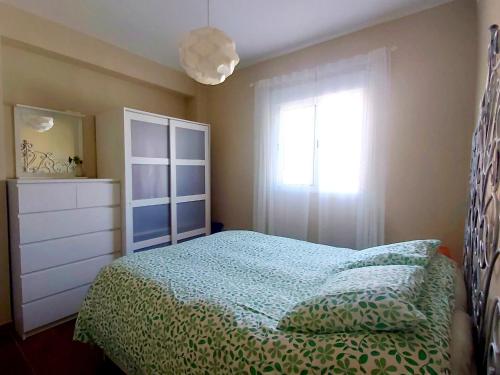 a bedroom with a bed and a dresser and a window at Enladrillada.Parking Incluido.Cuna del Flamenco in Seville