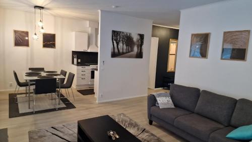 a living room with a couch and a table at Stylish apartment in town centre in Sotkamo