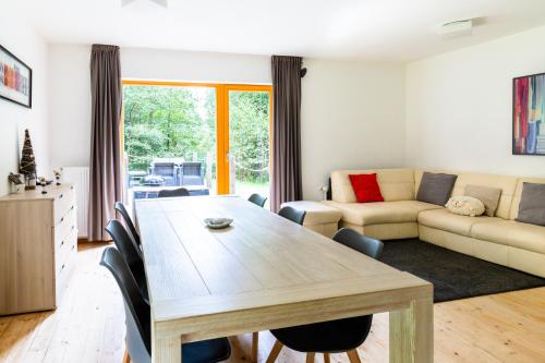 a living room with a table and a couch at Horská chata Harrachov in Harrachov