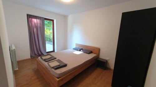 a small bedroom with a bed and a window at Rooms and apartments Biš 