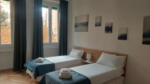 a bedroom with two beds and a window at Civico 37 Casa Vacanze Porta Romana in Milan