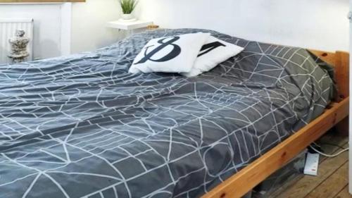 a bed with a black and white comforter at Charles Flats Dublin in Dublin