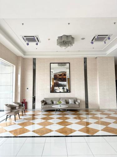a lobby with a couch and a checkered floor at Apartement 2BR sky house BSD in Cilenggang