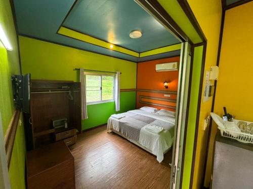 a room with a bed and a bathroom with a tub at Fine Times Resort in Ko Chang