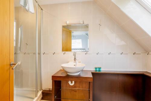 a bathroom with a sink and a shower at The Gables Penthouse in Poole