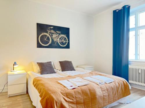 a bedroom with a bed with a bike painting on the wall at Perfect Apartment For Travelers On A Budget - But Still Wants Quality in Randers