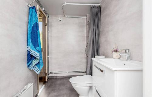 a bathroom with a toilet and a sink and a shower at Cozy Home In Sikns With House Sea View 