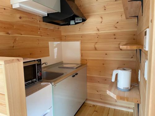 a small kitchen with a stove and a microwave at Biwako Hills Resort - Vacation STAY 94635v in Takashima