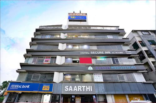 a tall building with a sign on top of it at FabHotel Saarthi Inn in Surat