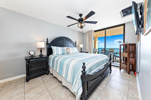 a bedroom with a bed and a ceiling fan at Phoenix East 904 in Orange Beach