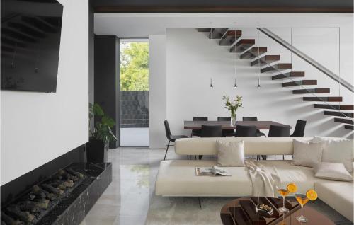 a living room with a couch and a staircase at Villa Soiree in Starigrad