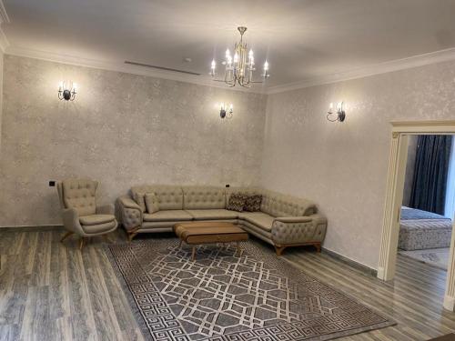 a living room with a couch and two chairs at Nohur Hotel Gabala in Gabala
