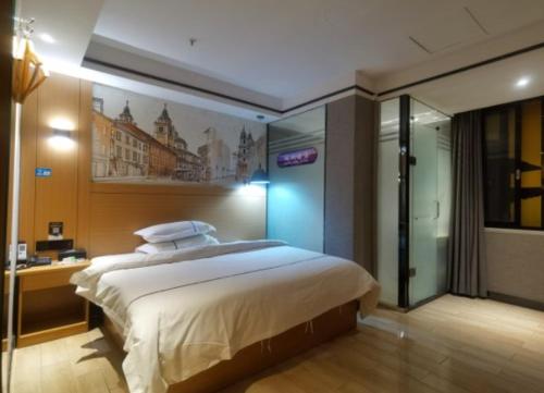 a bedroom with a large bed and a bathroom at Yi Nuo Hotel Guangzhou in Guangzhou