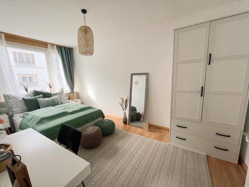a bedroom with a bed and a dresser and a mirror at Apartment mit großem Balkon in Hannover Nordstadt in Hannover