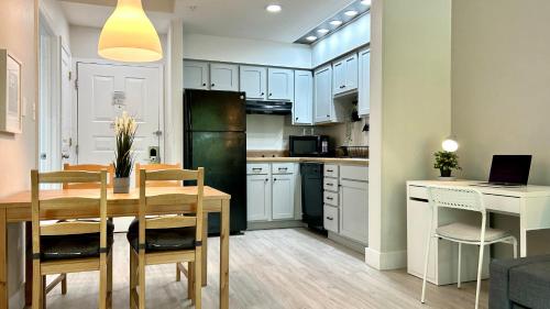 a kitchen and dining room with a table and a refrigerator at HSO - Family Apartments Close to Disney World & Universal in Orlando