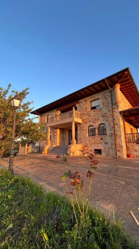 a large brick building with a staircase in front of it at Villa Artegoikoa in Ibarrangelu