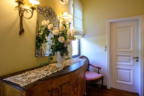 a room with a table with a vase of flowers on it at Senso Panorama Villa and Suite in Kalamata