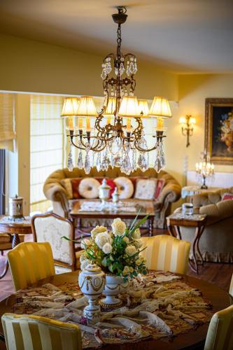 a dining room with a table and a chandelier at Senso Panorama Private Luxury Villa in Kalamata