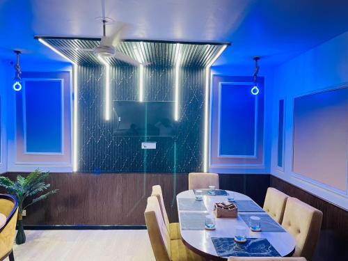 a dining room with a table and blue walls at THE ROYAL PRESIDENCY INN in Lucknow