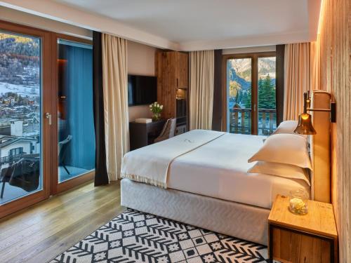 Postel nebo postele na pokoji v ubytování Le Massif Hotel & Lodge Courmayeur The Leading Hotels of the World