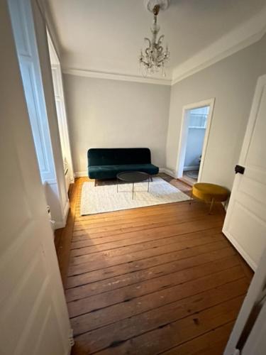 a living room with a green couch and a wooden floor at Gamla Stan in Stockholm