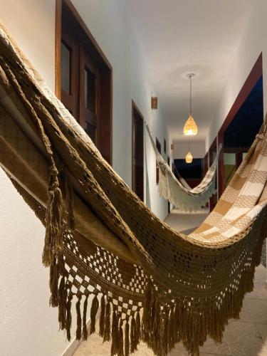 a hammock hanging on a wall in a room at Casa da Lagoa in Jijoca de Jericoacoara