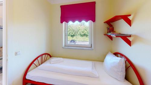 a room with a bed with red arrows on the wall at NeuKlosterhof App. 18 in Pelzerhaken