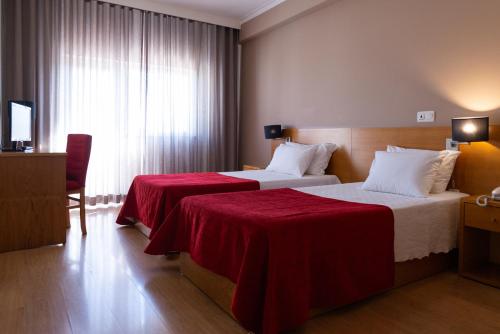 Postel nebo postele na pokoji v ubytování Hotel Durao