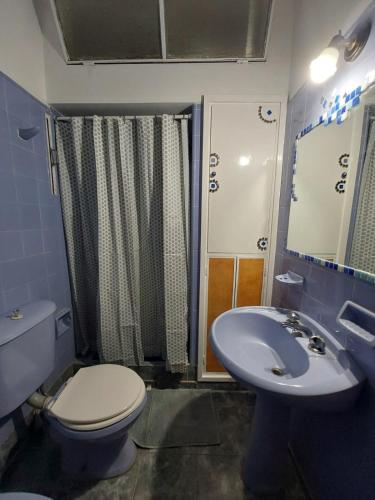 a bathroom with a toilet and a sink at MAILY Guest House in Alta Gracia
